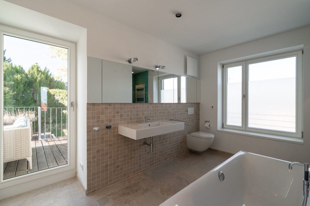 Helles Badezimmer mit Badewanne und Fenster