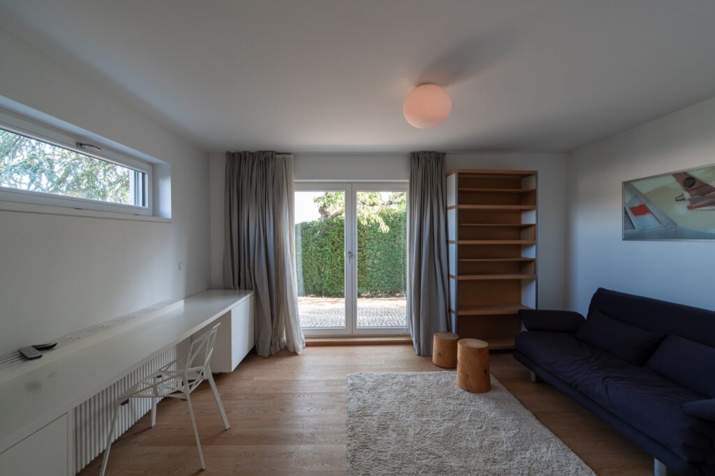 Weiterer Wohnraum mit Sofa und Zugang ins Freie